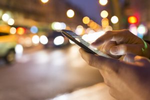 Man using his Mobile Phone in the street, bokeh